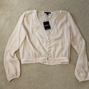 Cropped, dressy long sleeve shirt with cute button detailing